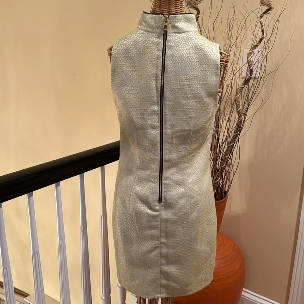 Sail to Sable green dress with silver white and black trim around neck